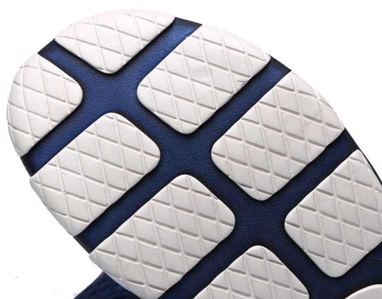 Close-up of the durable rubber outsole on men's lightweight breathable beach flip flops, showcasing traction and grip design.