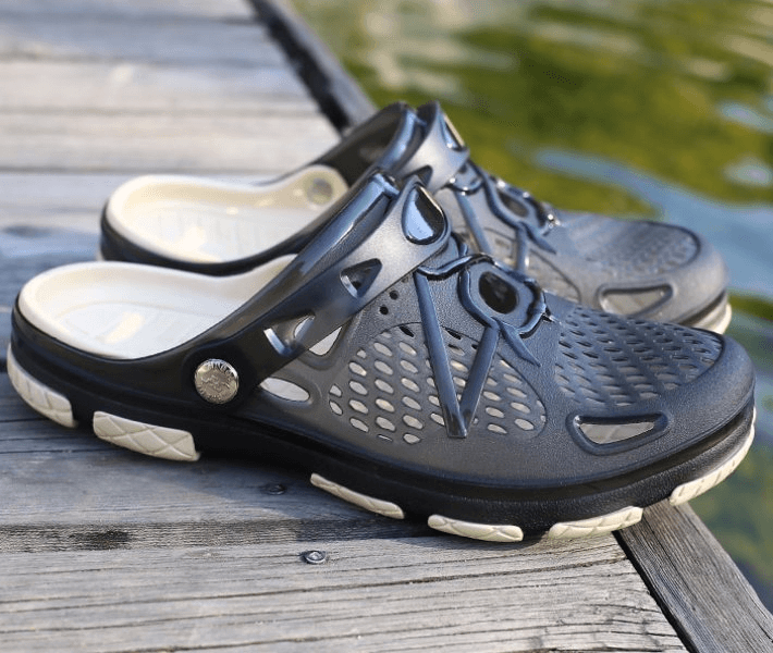 Men's lightweight breathable beach flip flops with locking strap on a wooden dock.