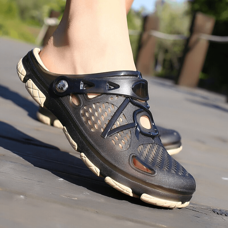 Men's open heel beach flip flops with locking strap in motion on wooden deck, showcasing breathable upper and durable outsole.