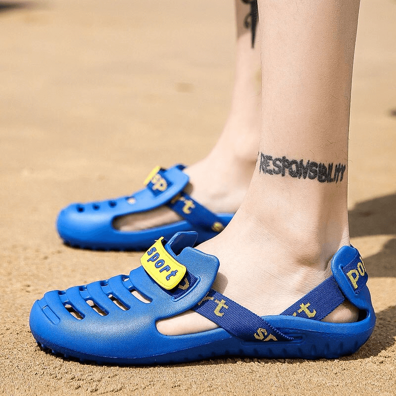 Blue men's outdoor beach shoes, lightweight flexible clogs, perfect for beach comfort and style, worn on sand.