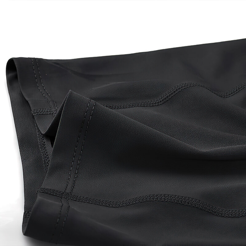 Close-up of black men's outdoor running shorts with elastic compression, patchwork design, made from polyester, spandex, and nylon.