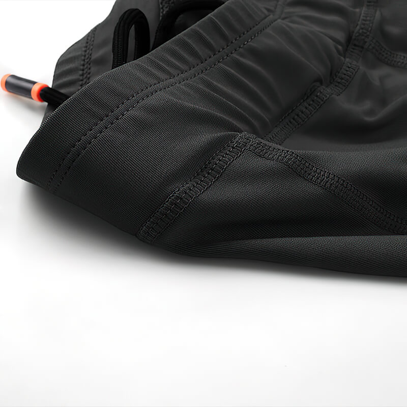 Close-up of black men's outdoor running shorts with elastic waistband and stitching details, showcasing stretchy compression fabric.