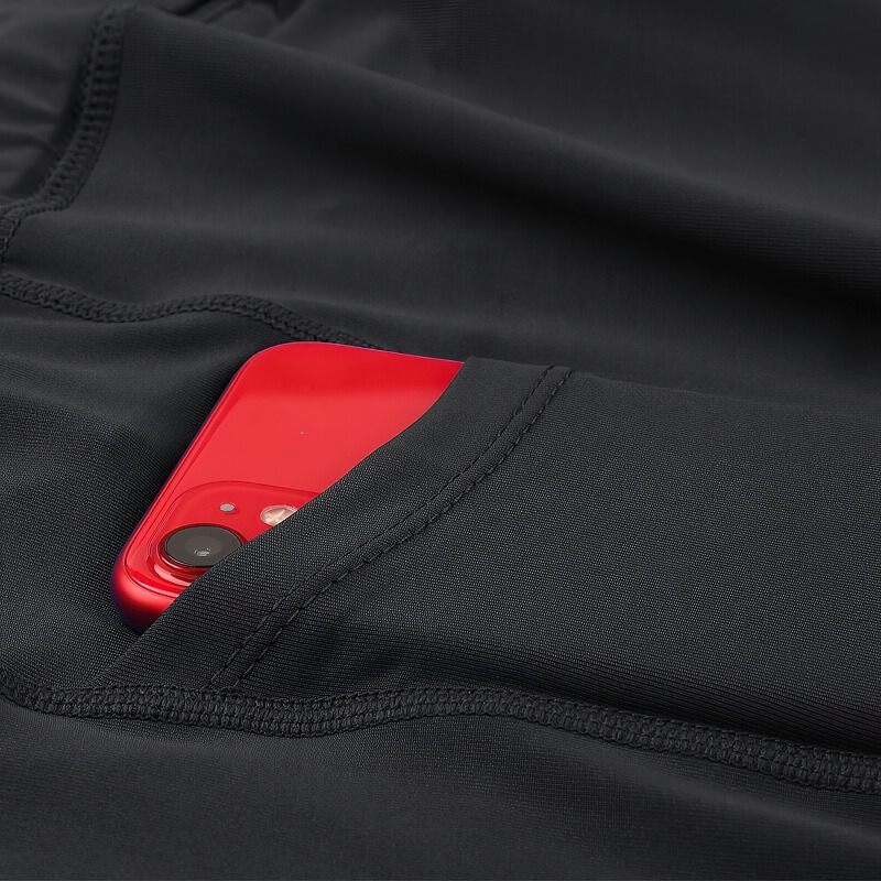 Close-up of men's outdoor running shorts with a smartphone in the side pocket, showcasing fabric texture and practicality.
