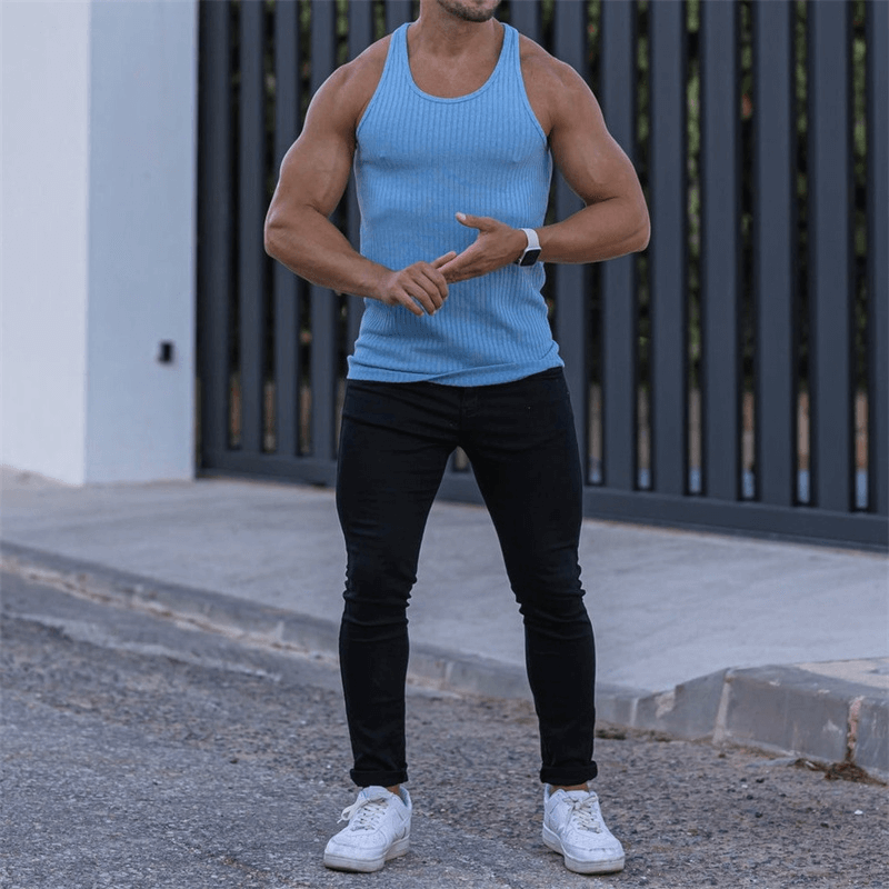 Man wearing a blue men's pure color sports tank top, fitness clothing, outdoors