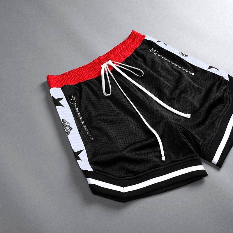 Men's black basketball shorts with red waistband, featuring stars and zippers, perfect for quick-drying performance on the court.