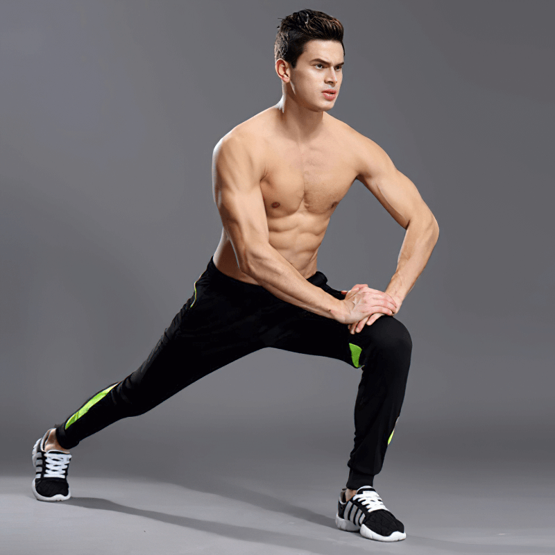 Man stretching in men's running sports pants with zipper pockets, designed for comfort and performance, perfect for active lifestyles.