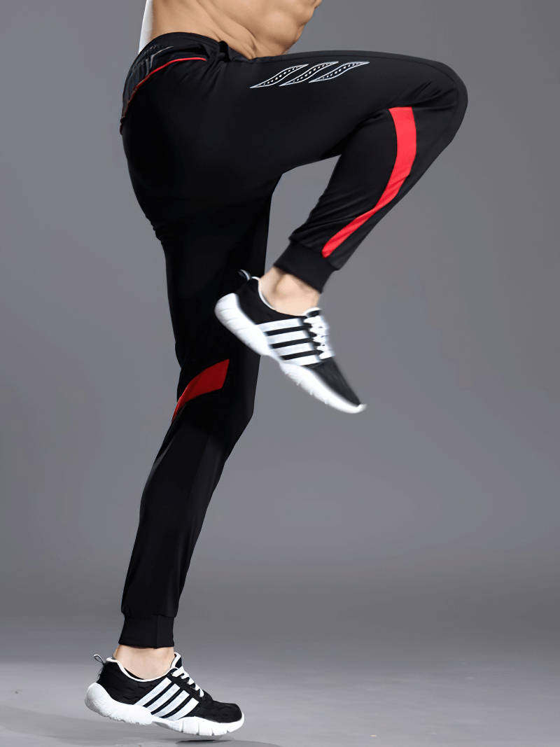 Men's running sports pants with zipper pockets in action, showcasing comfortable polyester design, full-length fit, and elastic waist.