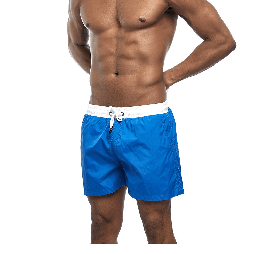 Men's blue quick dry swimming shorts, solid pattern, beachwear. Lightweight and durable polyester. Perfect for summer activities.
