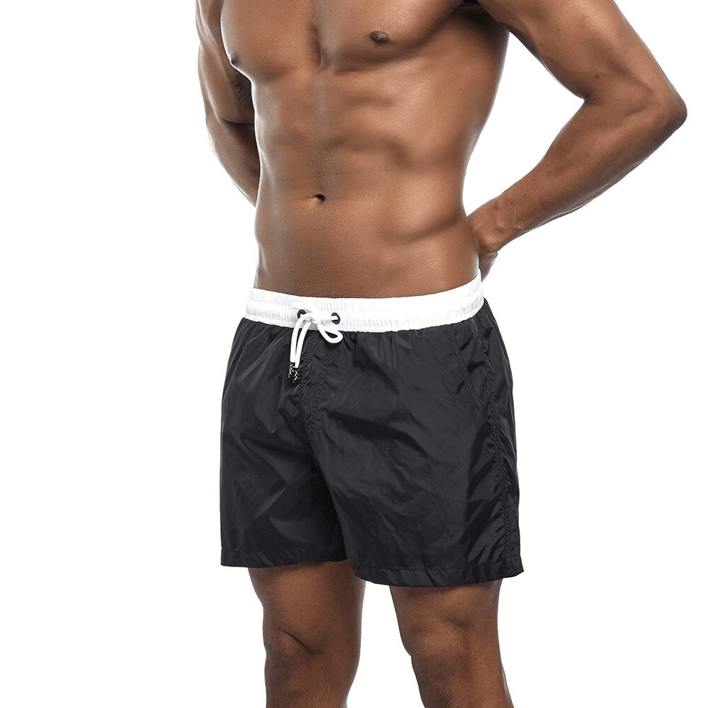 Men's quick dry swimming shorts in black, designed for beachwear with a solid pattern, lightweight and comfortable fit.