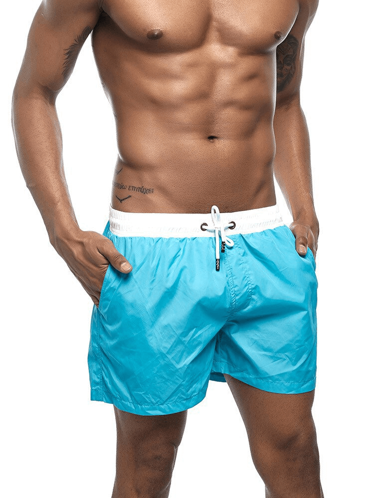 Men's quick dry swimming shorts in blue, perfect for beach wear, designed with a solid pattern and comfortable fit.
