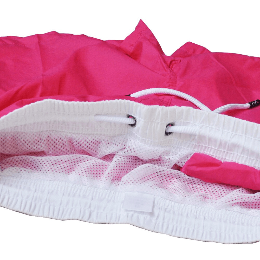 Close-up of pink men's quick dry swimming shorts with white mesh lining and drawstring, perfect for beach activities.