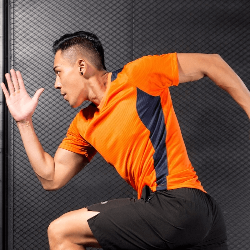 Man sprinting in orange short sleeve football t-shirt, quick-dry gym clothing. Ideal for running and training. SF0497.