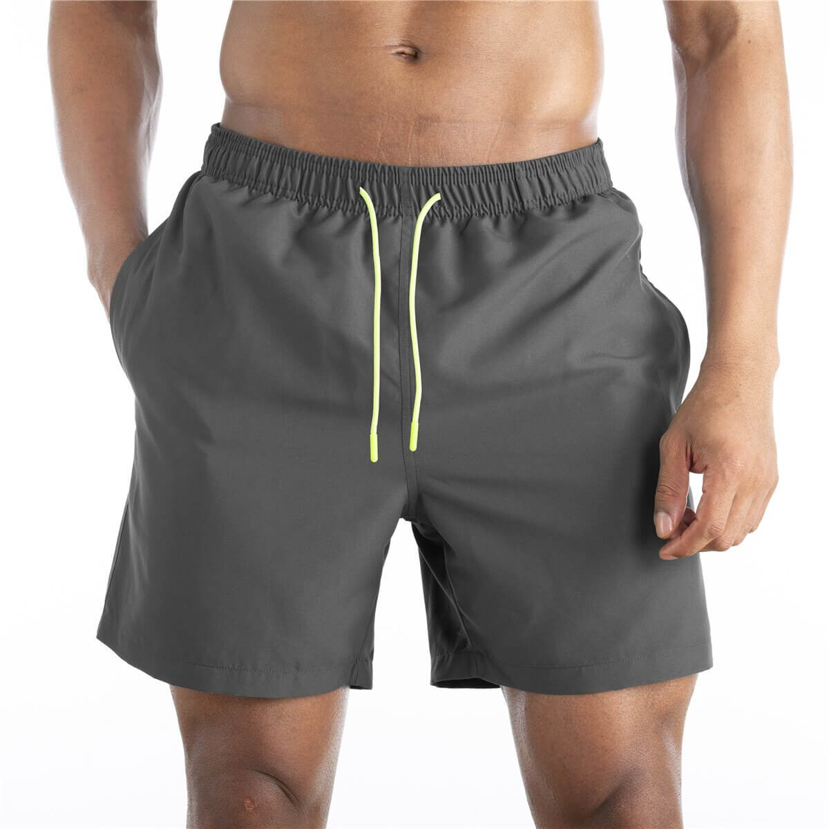 Men's solid color boardshorts with pockets and drawstring, featuring quick-dry polyester material for comfortable swimwear fit.