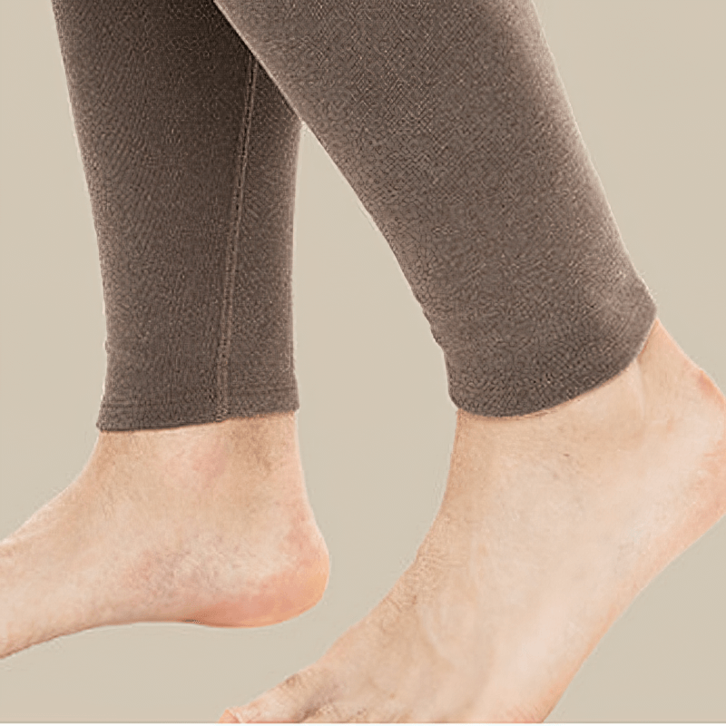 Close-up of men's solid color tight thermal pants with elastic waistband, heavyweight fabric, showing ankle detail.