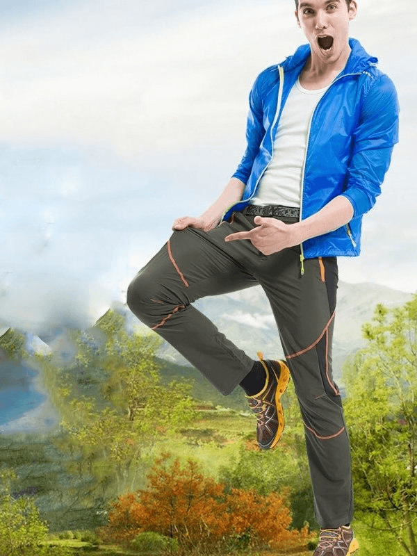 Man wearing Men's Sports Breathable Quick-Drying Hiking Pants SF0241, ready for adventure in a picturesque outdoor setting.