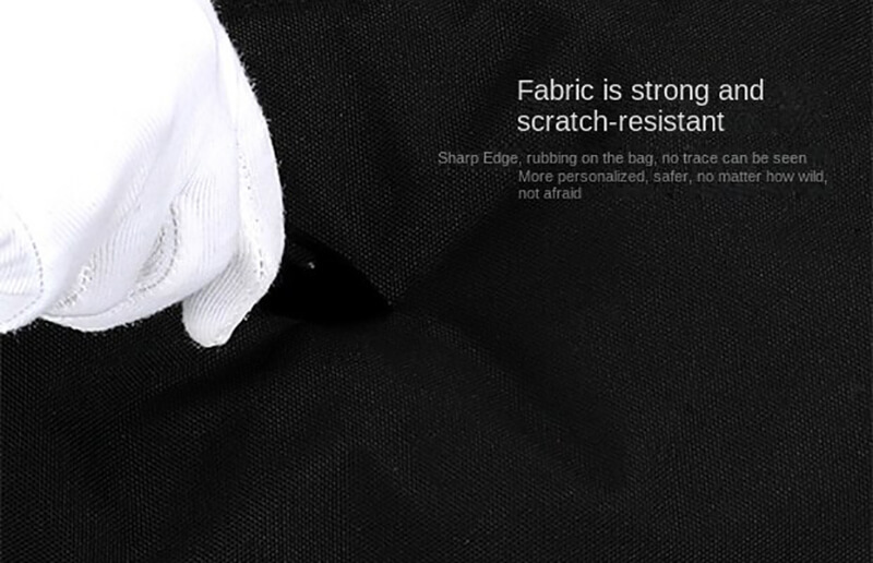 Gloved hand showing the scratch-resistant and strong fabric of men's crossbody sports bag.