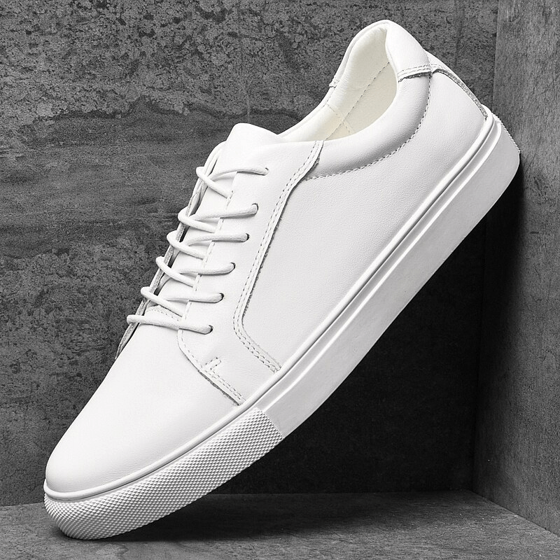 Men's sports leather sneakers with flat sole, massage insole, and lace-up design in white, providing comfort and modern style.