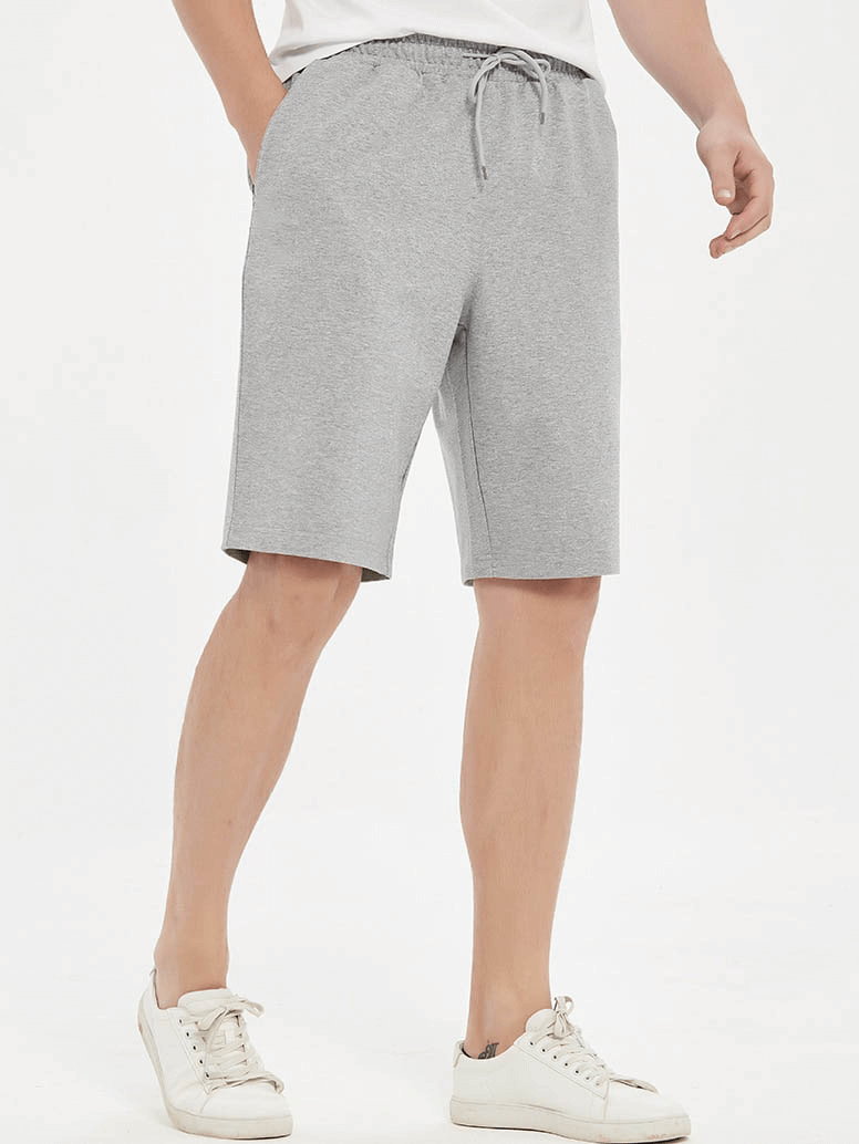 Men's grey sports loose cotton shorts SF1088 for running, shown on model, highlighting comfort and mobility.