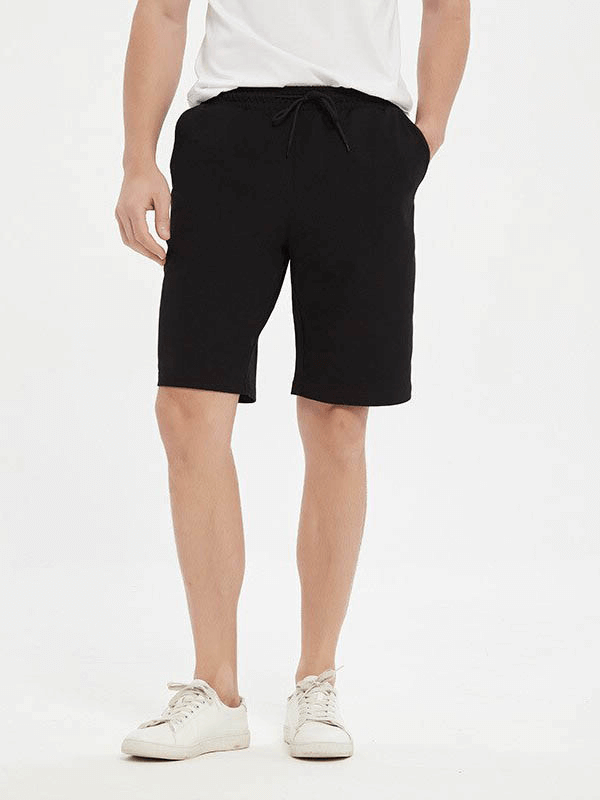 Men's black sports loose cotton shorts for running, featuring a solid pattern, ideal for enhanced mobility and comfort.