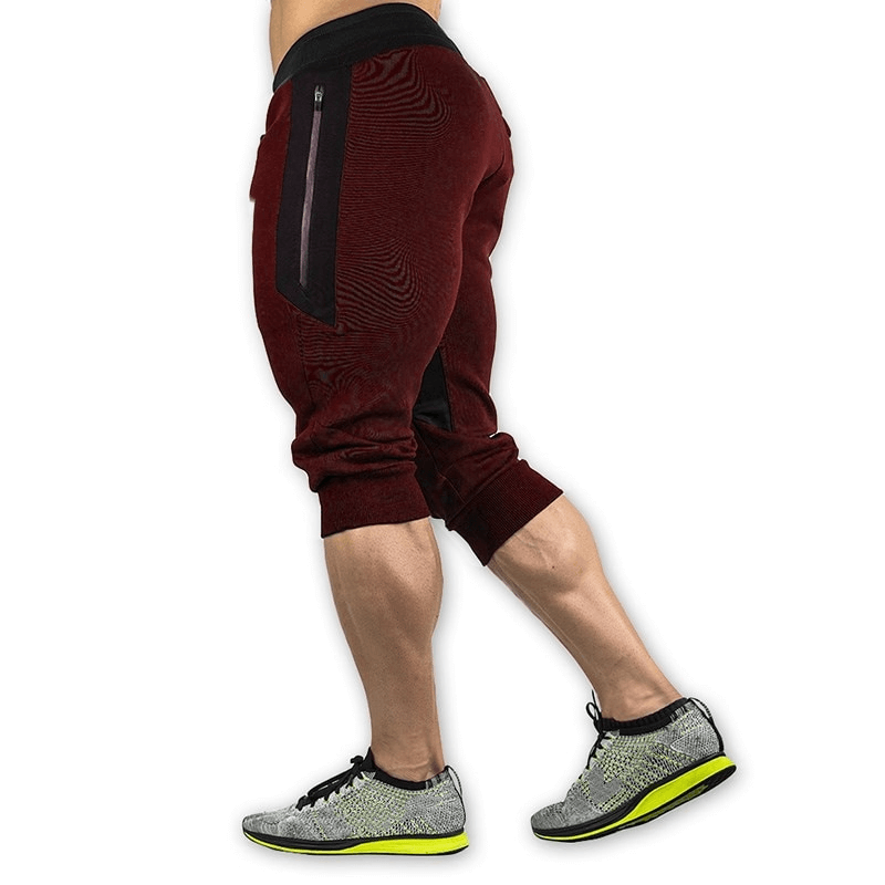 Men's sports shorts in burgundy with zippered pockets for secure storage, ideal for running or training, made from cotton and polyester.
