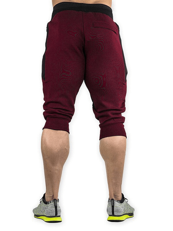 Back view of men's burgundy sports shorts with zippered pockets, ideal for running and training; breathable cotton-polyester blend.