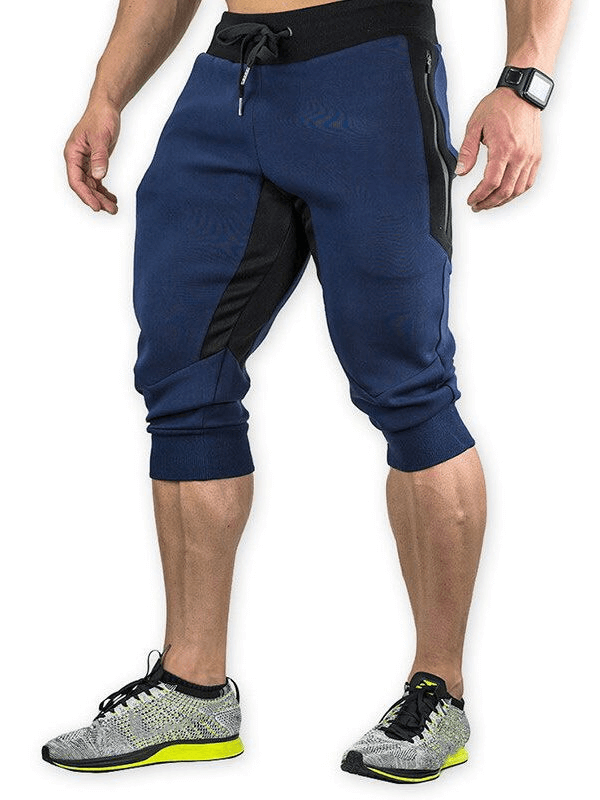 Men's blue sports shorts with zippered pockets for running, featuring breathable cotton and polyester blend fabric.
