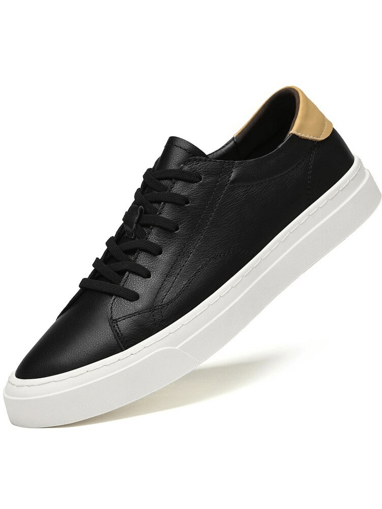Men's sporty flexible flat sole sneakers in black with genuine leather uppers, featuring a tan heel accent and white synthetic outsoles.