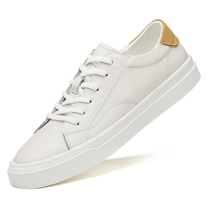 Men's sporty flexible flat sole sneakers in white leather with tan accents, featuring a casual lace-up design and synthetic outsole.
