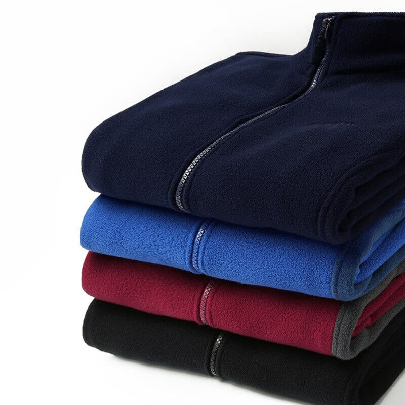 Stack of men's stand collar fleece jackets in navy, blue, red, and black. Warm polyester outerwear with classic zipper closure.
