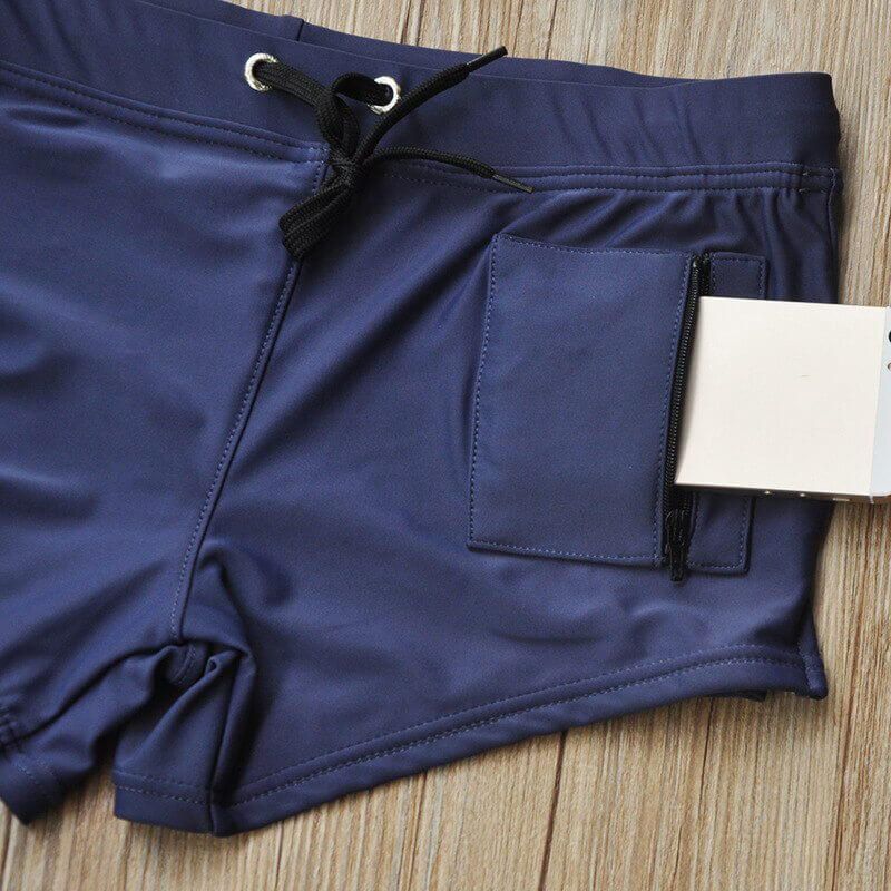 Men's swim trunks with zipper pocket in navy blue, made from quick-dry polyester, showcasing a secure pocket for modern practicality.