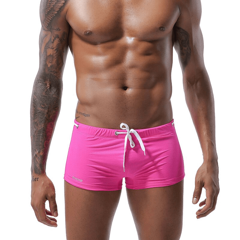 Men's swimming drawstring boxers in vibrant pink with adjustable fit, ideal for beachwear and swimming. Snug fit with classic style.