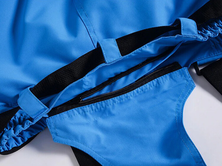 Close-up of vibrant blue men's ski pants showcasing windproof, waterproof fabric with black accents. Ideal for winter sports enthusiasts.