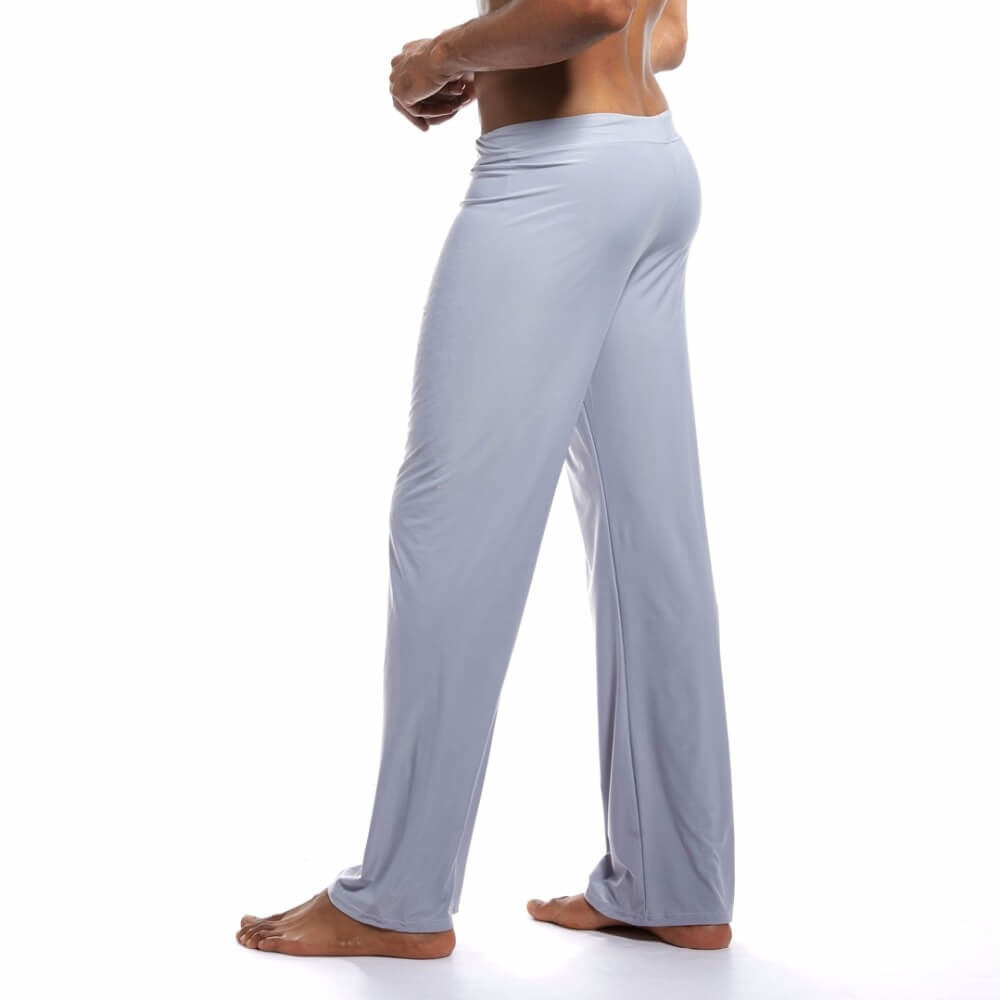 Side view of a person wearing men's loose full-length yoga pants in light grey, designed for fitness and motion flexibility.