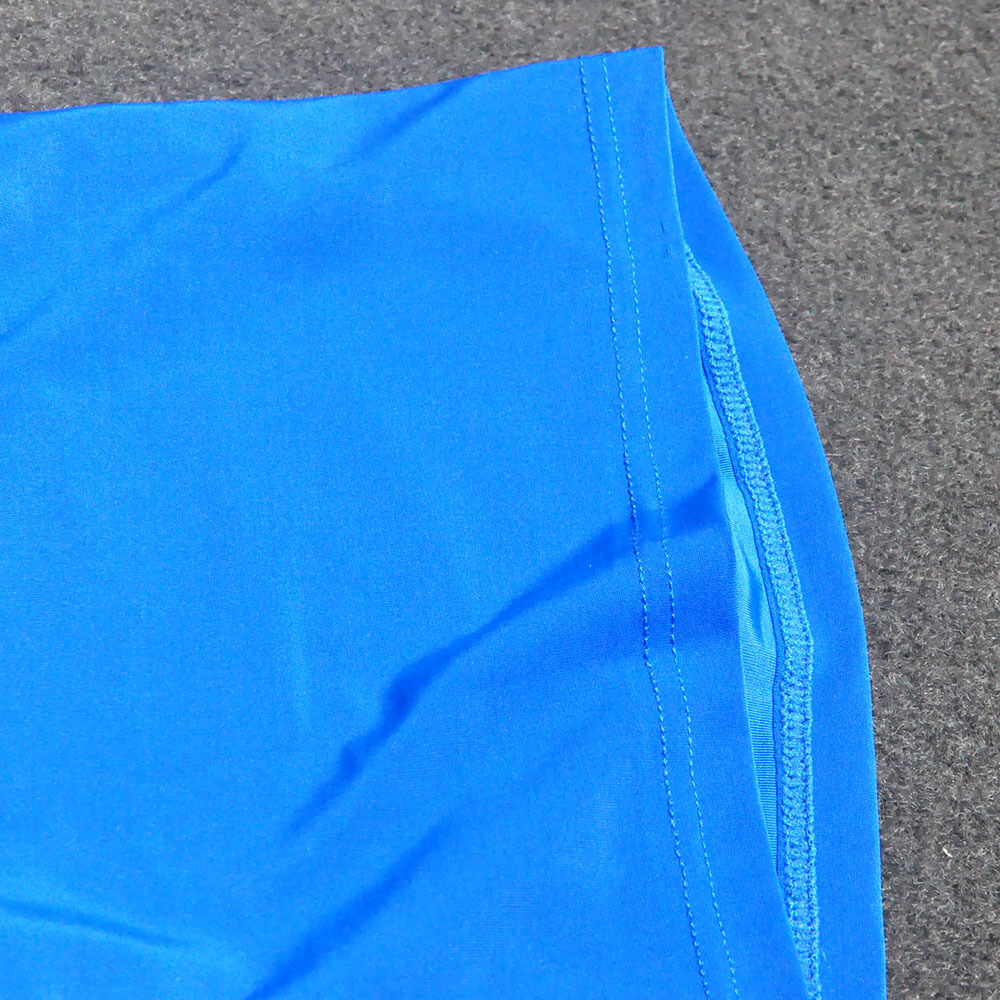 Close-up of blue men's yoga pants showing durable stitching and smooth fabric.