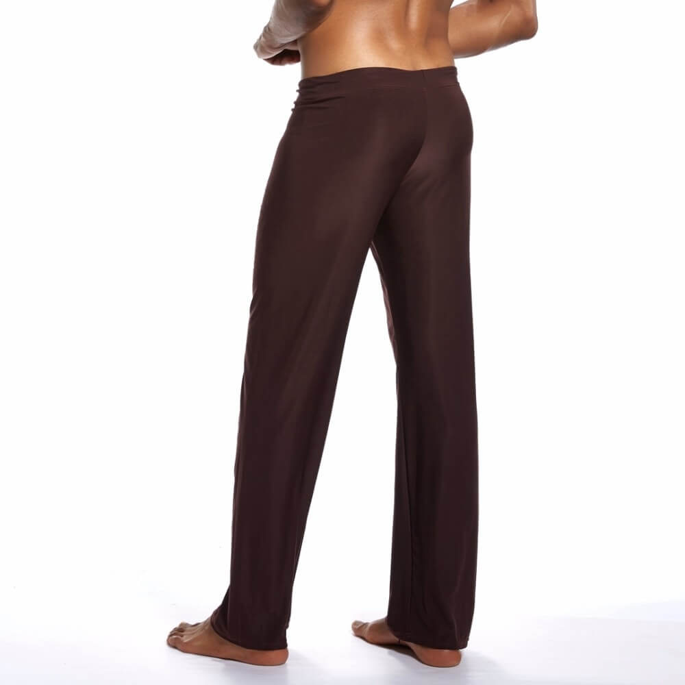 Back view of men's yoga loose full-length pants in brown, perfect for flexibility in yoga sessions.