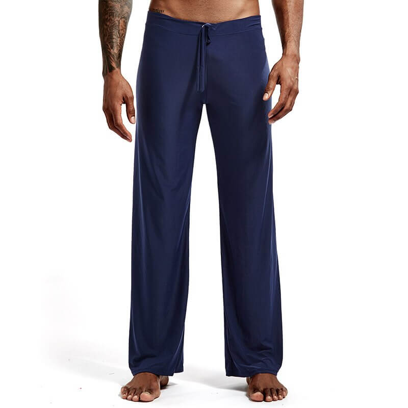 Men's full-length yoga pants in navy blue with drawstring, ideal for fitness and flexibility. Model showing front view.