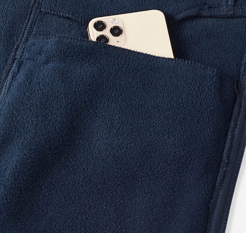 Navy fleece hiking jacket with phone in pocket, showcasing convenient storage.