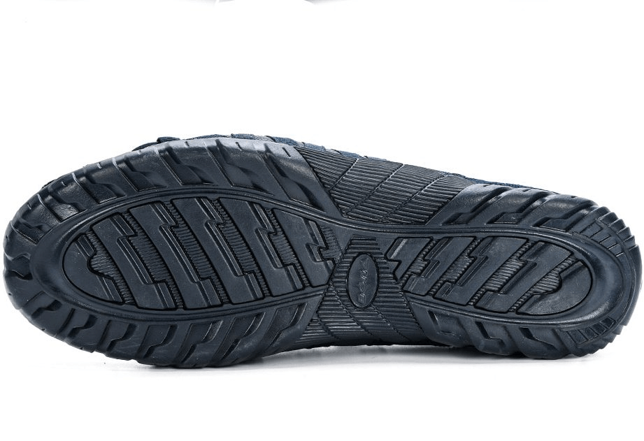 Close-up of flexible rubber outsole on men's breathable sneakers for lightweight support and all-day comfort.