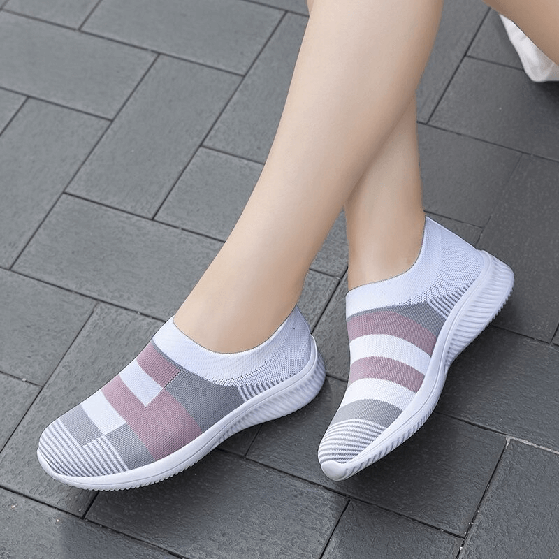 Woman wearing mesh breathable women's shoes SF0267, stylish sports sneakers with solid pattern, perfect for casual or active wear.