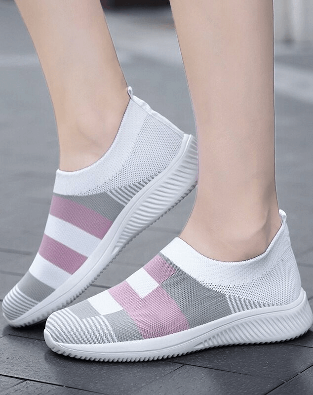 Mesh breathable women's shoes in pink and white, ideal for stylish activewear, featuring slip-on design and low heel for comfort.