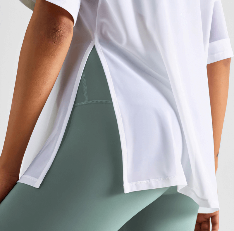 Back view of Mesh Casual Sports T-Shirt with short sleeves in white, perfect for women seeking quick-drying fitness wear. Model in green leggings.