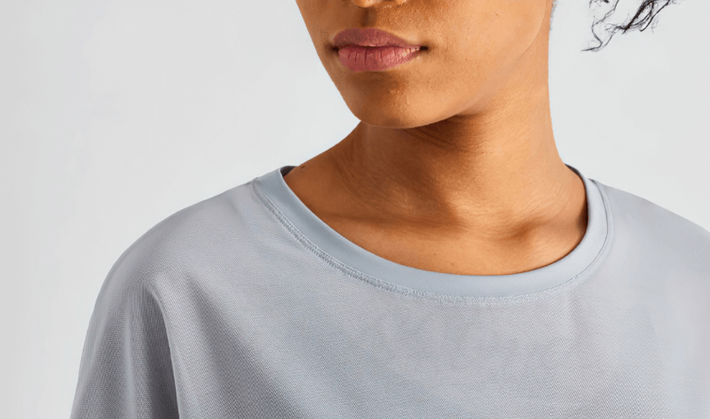 Woman wearing a light blue mesh casual sports T-shirt, short sleeves designed for quick drying and fitness activities.