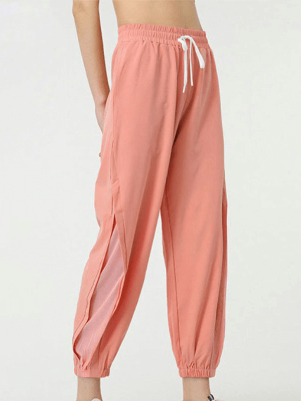 Peach mesh drawstring running trousers for women, ideal for yoga and sports, featuring elastic waistband and breathable design.