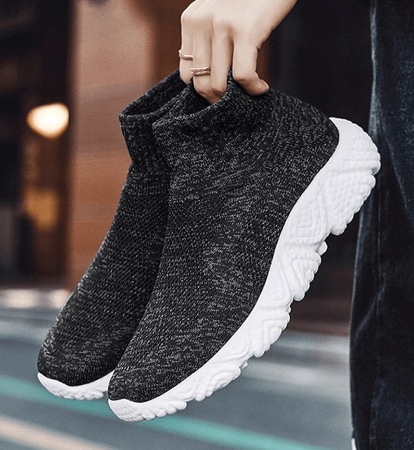 Unisex breathable mesh elastic sneakers, black with white sole, ideal for sports and casual wear, featuring slip-on design for comfort.