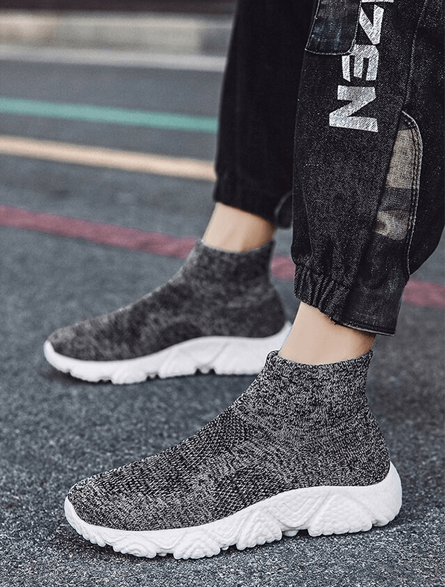 Unisex breathable mesh elastic sneakers, lightweight and comfy slip-ons perfect for daily wear, shown on a street walk.