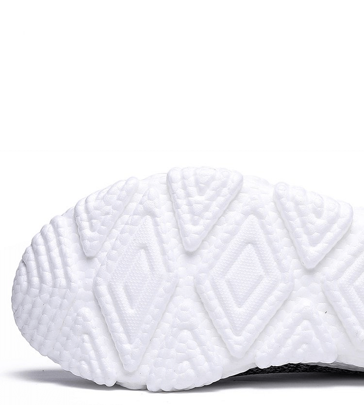 Close-up of white textured sole on mesh elastic breathable sneakers for optimal comfort and grip