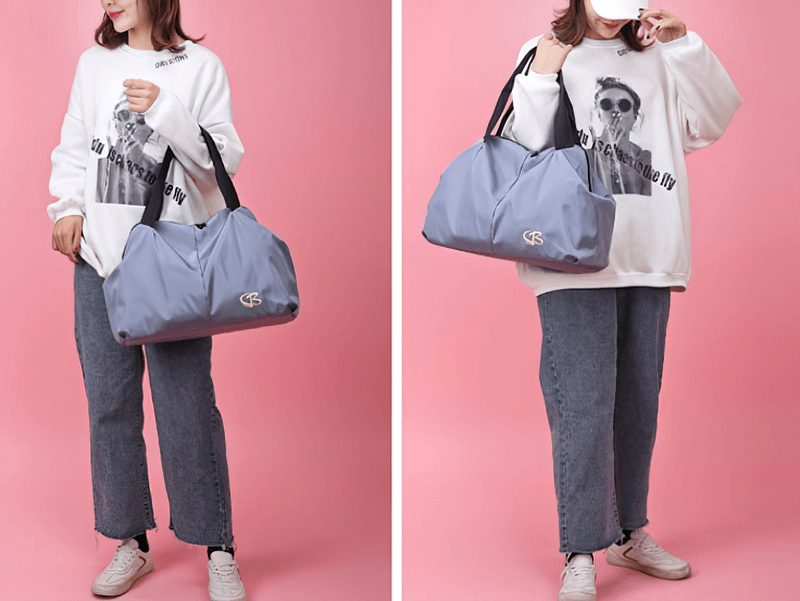 Stylish woman carrying a blue large capacity waterproof gym bag against a pink background, ideal for travel and fitness.