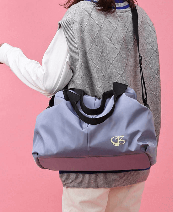 Woman carrying a purple multifunction waterproof large capacity gym bag, perfect for sports, swimming, fitness, and travel activities.