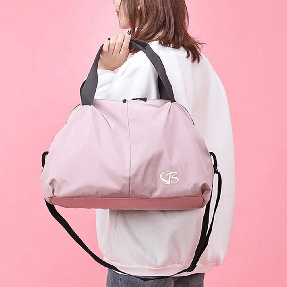 Pink large capacity waterproof gym bag held by woman in white sweater, ideal for sports and travel. Stylish and versatile design.