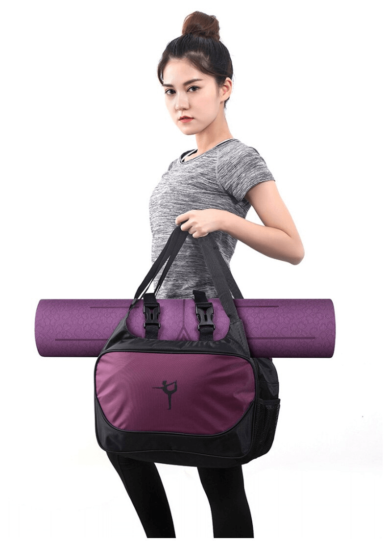 Woman holding a purple multifunctional waterproof sports bag with mat clip, ideal for fitness and outdoor activities.